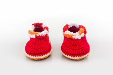 Little baby shoes. Kids knitted shoe handicraft.