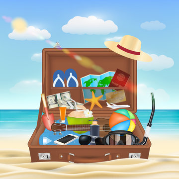 suitcase open with beach travel object on beach