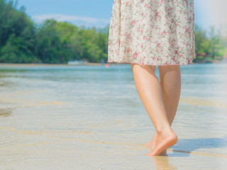 Beach travel - woman walking on sand beach. Closeup detail of female feet .Step up concept.