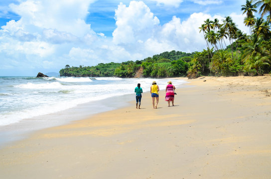 Group of friends walking on the beach