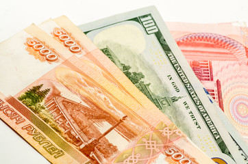 different currency banknotes. dollars, yuan and rubles on white