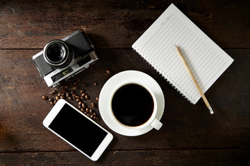 cup of coffee and smartphone on the wood