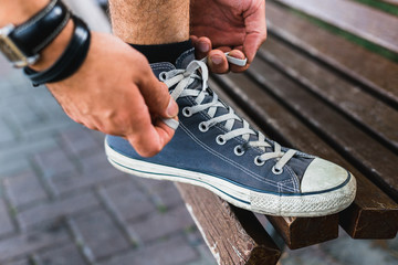 Hands Of Young Man Tying His Shoelaces, Closeup. Lifestyle Activity Footwear Concept