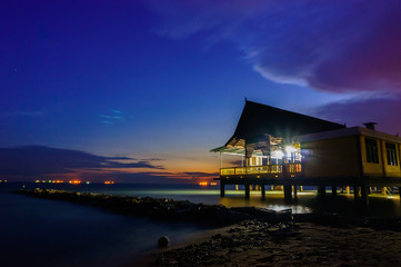 view of beach house with blue sky during sunset
