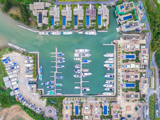 Naklejka premium Pier speedboat. A marina lot. This is usually the most popular tourist attractions on the beach.Yacht and sailboat is moored at the quay.Aerial view by drone.Top view.