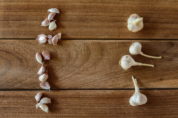 Garlic cloves and garlic bulb on wooden vintage background.