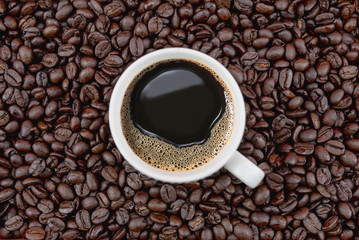 Coffee cup on coffee beans background