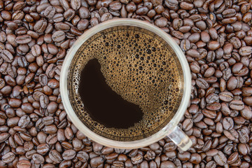 Coffee cup on coffee beans