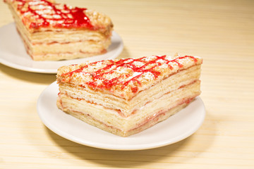 Tasty sweet piece of cake on wooden background