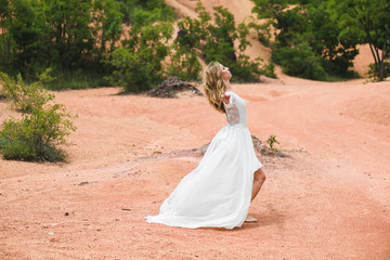 Fototapeta na wymiar Happy bride enjoy life outdoors. Beautiful woman in wedding dress.