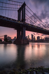 Manhattan bridge during sunset view from the rocks