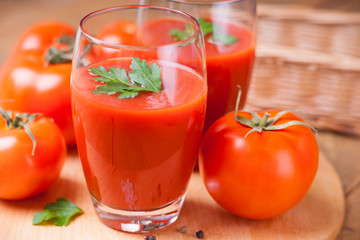 Glasses of fresh tomato juice and tomatoes 