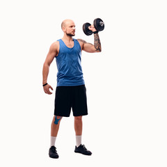 Shaved head male holds dumbbell.