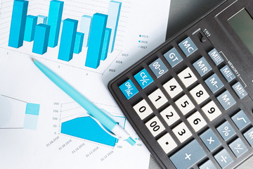 Checking accounting report on business table. Calculator