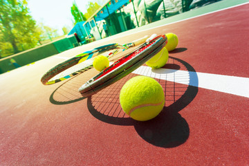 Tennis balls and racket on the grass court