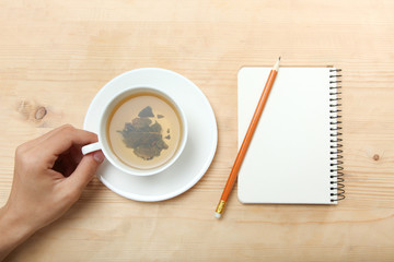 A left-hander holds a cup