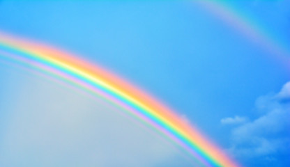 Double rainbow in sky with clouds