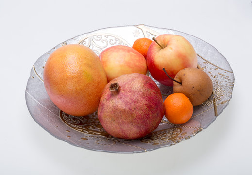 mix fresh fruits on plate isolated on white