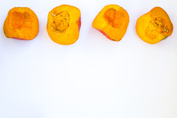 Cut a piece of ripe pumpkin on a white background
