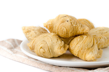 Curry puff snacks on white dish with white background.