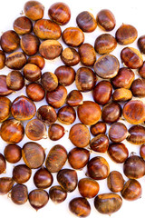 Group of edible chestnuts. Dark background.