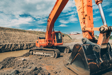 Close-up details of excavator scoop during highway construction works. Industry with machinery