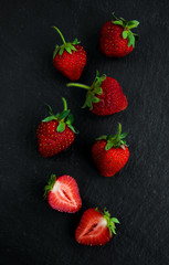 Strawberries on a black stone background