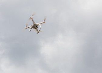 Drone quad copter on a background of gray clouds