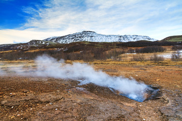 The colorful geyser landscape at the Haukadalur geothermal area, part of the golden circle route, in Iceland