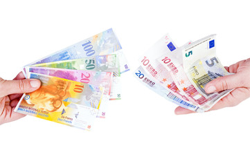 euro and Swiss franc in the hands of