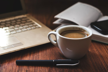 Laptop, cup of coffee and notepad. Freelance, business concept