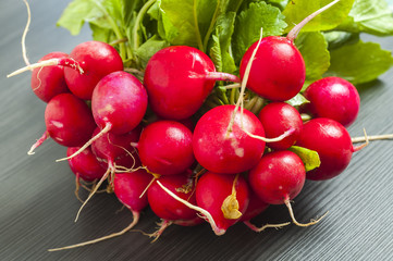 Fresh bunch of radish on wooden table