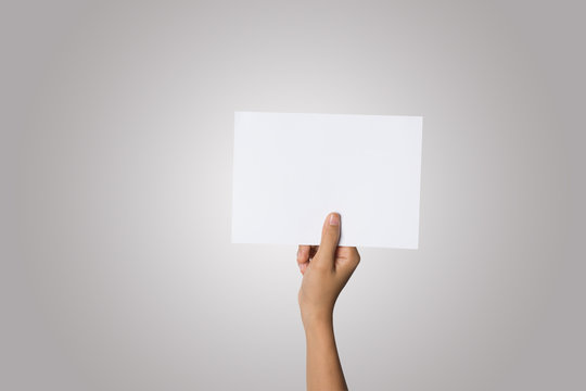 Close Up of woman hand holding blank paper isolated on white background
