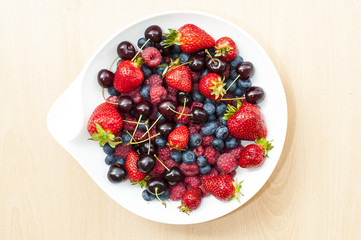 Bowl of berries and cherry