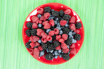 Berry fruits in summer with strawberries, blueberries and raspberries