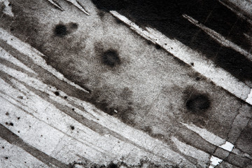 Stains and smears of  black ink on paper, abstract background, macro texture