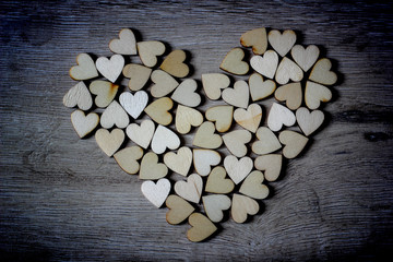 Heart shape from natural tree. Lovely heart shape by wooden small hearts on rustic wood table. Love theme concept with wooden hearts for Valentine's background and love theme.