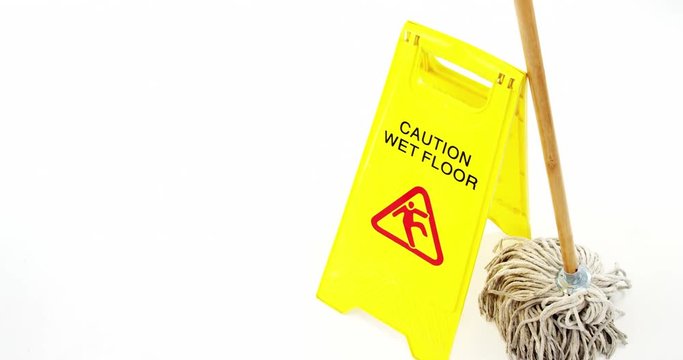 Mop with wet floor caution sign