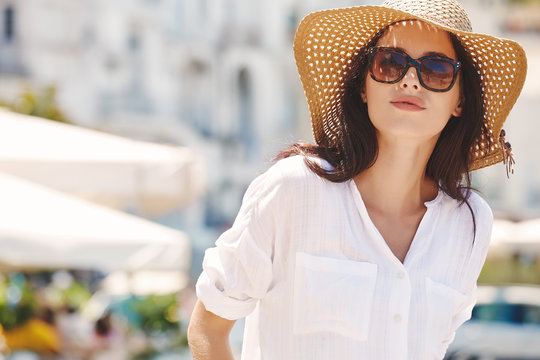Young beautiful woman with sunglasses walking the streets of an Italian town