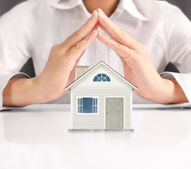 Mortgage concept by house from hand