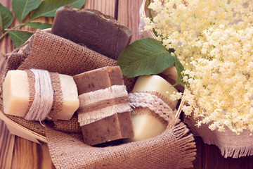 Decorated pieces of various dry soap in a basket with white elder