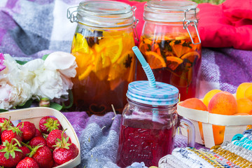 Fototapeta na wymiar Picnic in the outdoor with strawberry, apricots and cold beverages