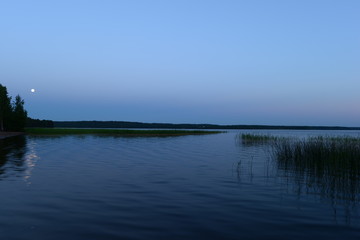 White nights moon over the lake time before dawn