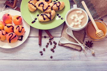 Breakfast of coffee, croissants, apricots, honey, cinnamon and anise