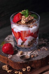 Glass with cereals, yoghurt and fresh strawberries