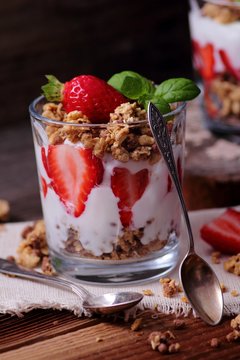 Fresh strawberries, light yoghurt and granola in a glass