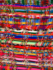 Columns of folded colorful blankets in bolivian street market, La Paz, Bolivia.