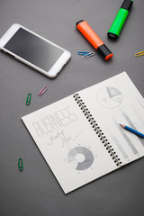 Creative sketch in spiral notepad with laptop on desk. Business starup plan.