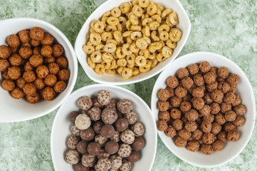 top view of various cereals in colorful bowls