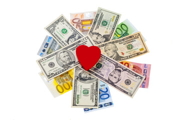 Love and money concept. Heart on European and American money